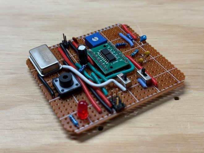 Photo of the clock. It is a messy build on perfboard/veroboard.